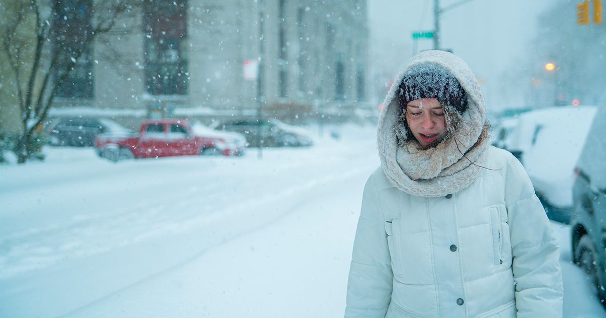 woman walking in a blizzard
