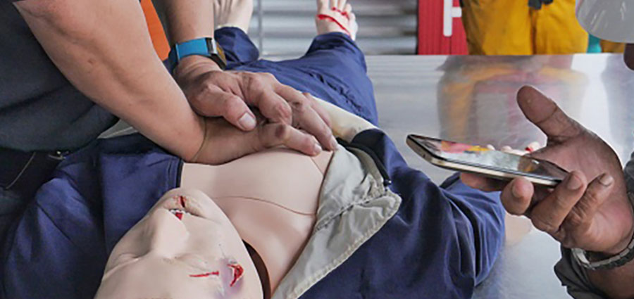 Student practicing CPR on dummy